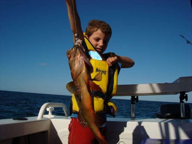 my six year old boy Cliff with his first coral trout